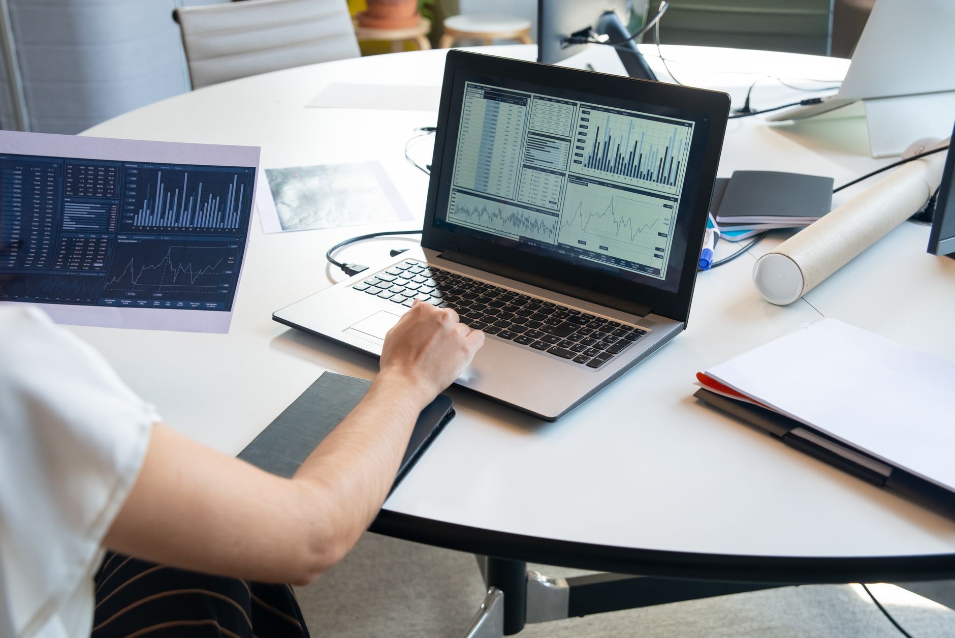 Professional reviewing organized data on a laptop